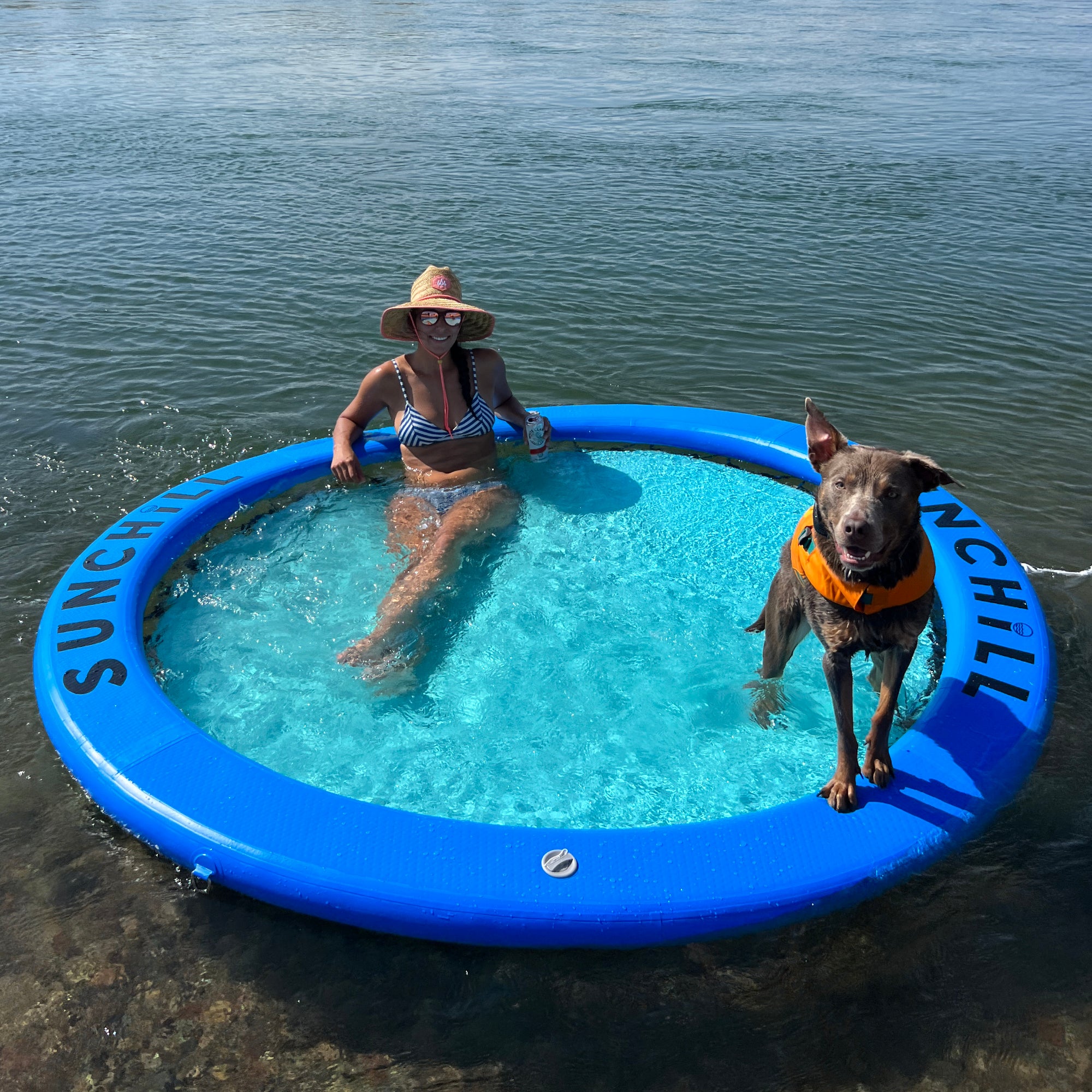 Woman and dog relaxing on a Royal Blue Sunchill water hammock.