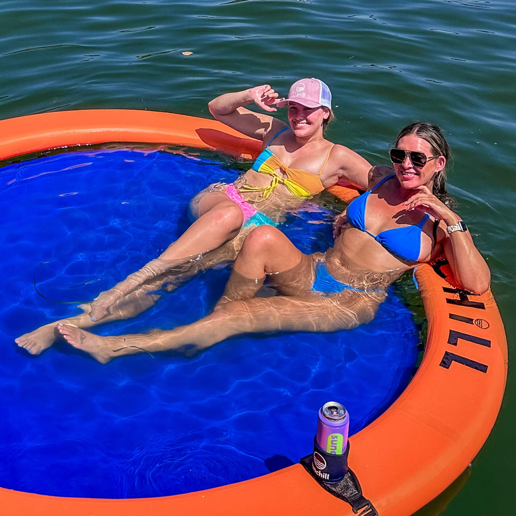 Female influencers sitting on orange Sunchill Water Hammock